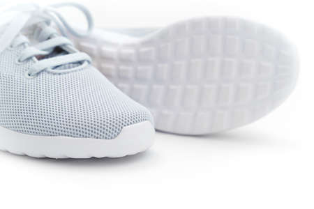 part of gray sports sneakers with pink stripes on a white background. adidasのeditorial素材