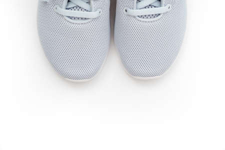part of gray sports sneakers on a white background.の写真素材