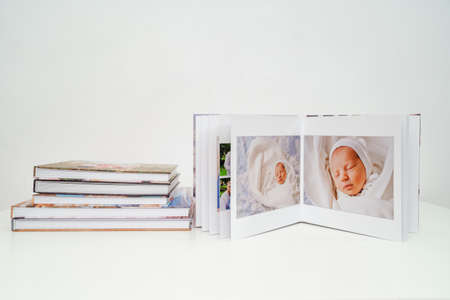 on white background photobooks. open photo album from photo shoot with a newbornの写真素材