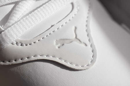 puma. part of white sneakers with laces on a white background.のeditorial素材