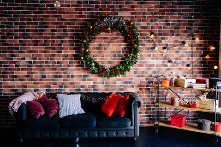 beautiful big New Years wreath on a brick wall above the sofaの写真素材