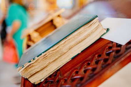 an old book of prayers on a table in the church. antique Bible.の写真素材