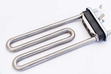 repair of washing machine. new tubular electric heater in hands of a repairmanの写真素材