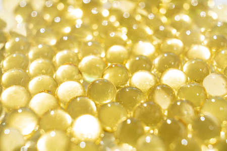 soft yellow gelatine capsules. close-up. pharmaceutical production.の写真素材