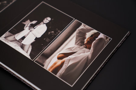 open photobook from a photo shoot of an attractive woman on a black background.の写真素材