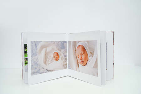 on white background photobook from photo shoot with a newborn child