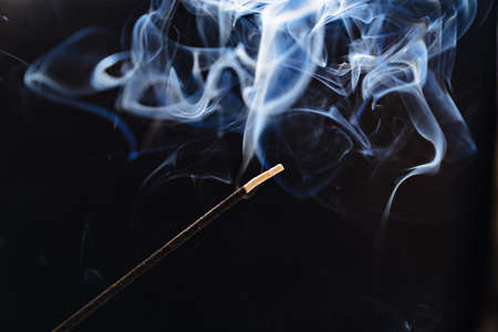 smoke from an aromatic stick on a black background.の写真素材