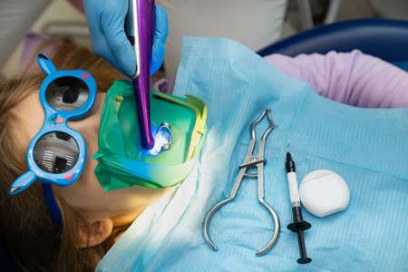 the dentist uses Cofferdam for the treatment of a childの写真素材