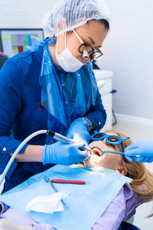 kid with oral dilator at dentists appointment. treatment of teethの写真素材