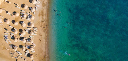 over beach of hotel. umbrellas and sunbeds on coast of sea.