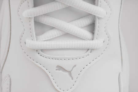 puma. part of white sneakers with laces on a white background.のeditorial素材