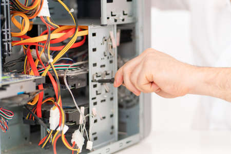 a man installs hard disk . computer repair shop. professional services.