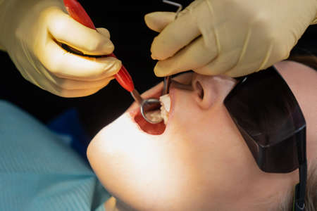 real. dentist examines patients teeth. regular care and prevention.の写真素材