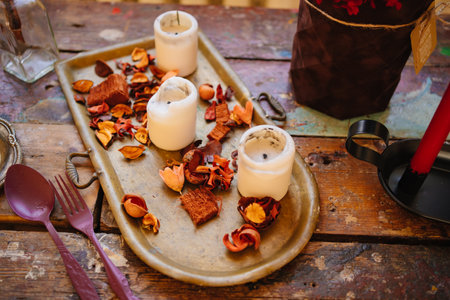 white candles and dried flowers on a tray as a retro style decorの写真素材
