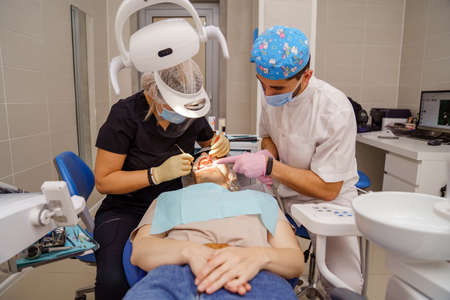 dentist brushes teeth of patient. regular care and prevention.のeditorial素材