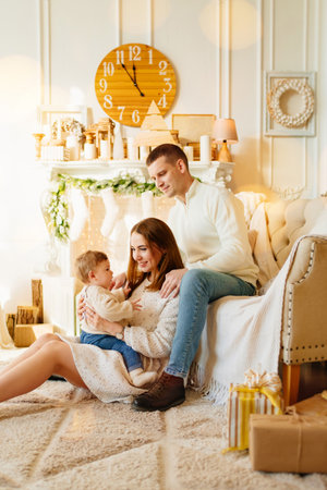 happy family by the fireplace and Christmas tree. New Years holiday.の写真素材