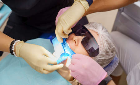 real. dentist prepares for treatment of patients teeth