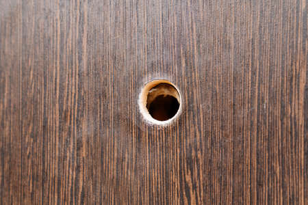 hole for a peephole on the brown front door.の写真素材