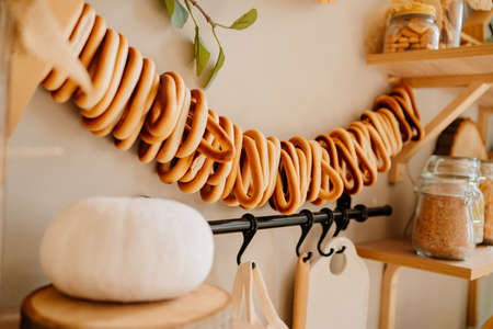 white pumpkin and bagels on a rope. organization of storage in the kitchenの写真素材