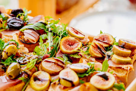 sandwiches with dried meat, figs and arugula.