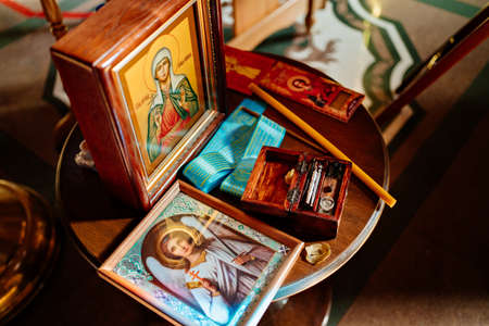 icons and baptismal set on the table in the Orthodox Church.