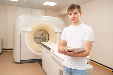 engineer fills in maintenance documents. computer tomograph.のeditorial素材