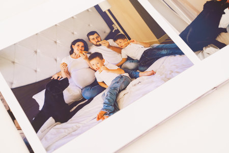 the pages of a photobook with a big happy family pregnancy photo shoot.の写真素材