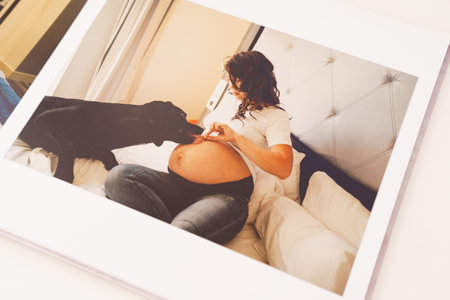 the pages of a photobook with a beautiful pregnancy photo shoot.の写真素材