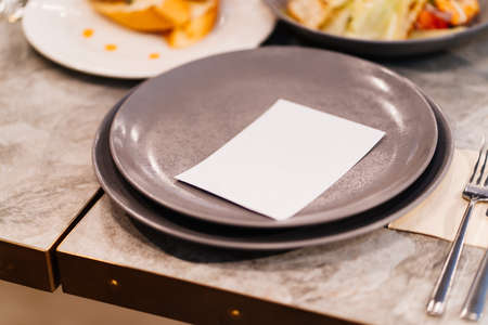 gray plates with a white card for the guests name.