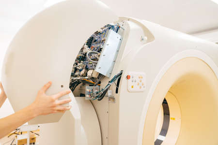 engineer removes cover of a computer tomograph.の写真素材