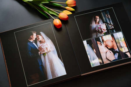 wedding photobook with photos of the newlyweds on a black backgroundの写真素材