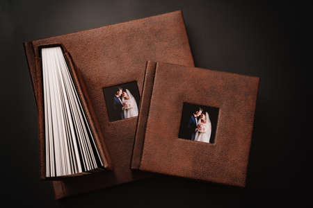 wedding photobooks in brown leather binding with photos on the coverの写真素材