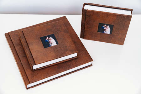 wedding photobooks in brown leather binding with photos on the coverの写真素材