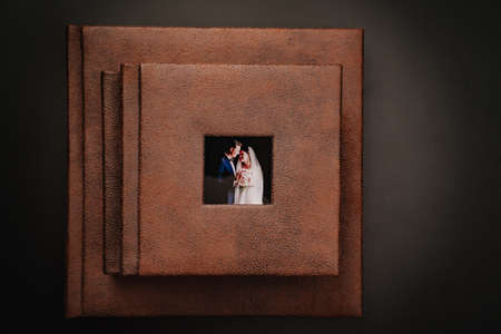 wedding photobooks in brown leather binding with photos on the coverの写真素材