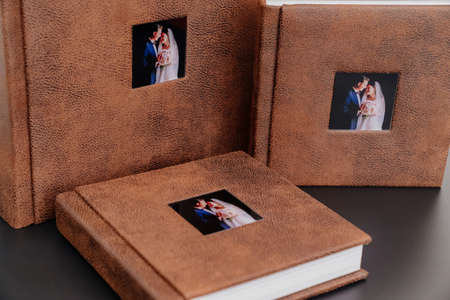 wedding photobooks in brown leather binding with photos on the coverの写真素材