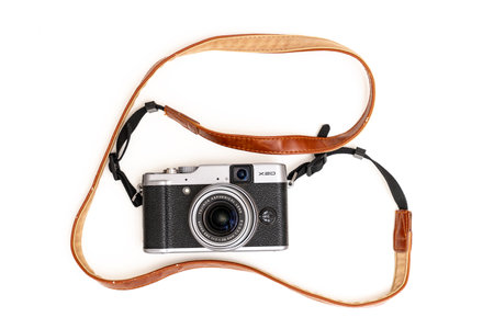 Fuji camera in retro style with a brown leather strap on a white background.のeditorial素材