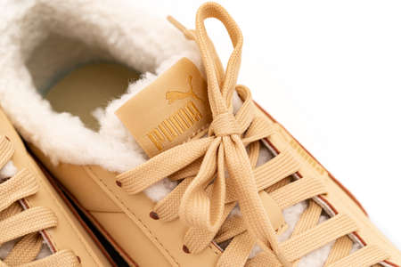 part of light brown winter sneakers Puma with fur on a white background.