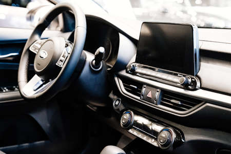 interior of new KIA car in car dealership. navigation and control.