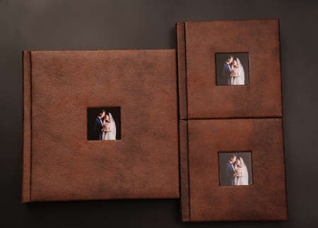 wedding photobooks in brown leather binding with photos on the coverの写真素材