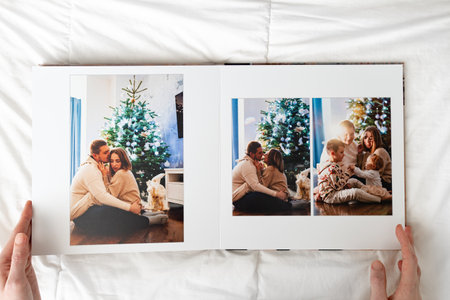 hands with book with new year photos of big family at home on a white backgroundの写真素材