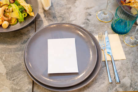 gray plates with a white card for the guests name.
