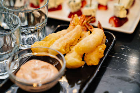 shrimp in batter with sauce on a plate.の写真素材
