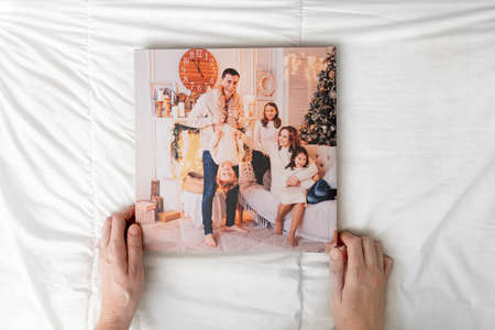 hands with closed photobook on a white background. family photo shootの写真素材