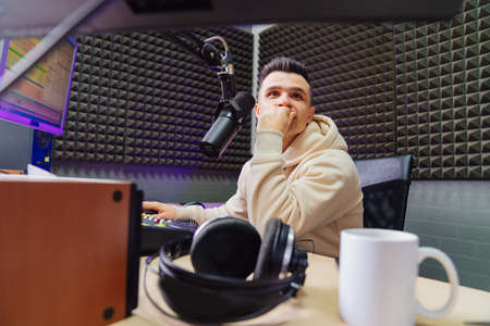 puzzled professional radio host broadcasts live reads newsの写真素材