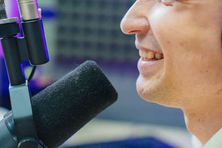 close up mouth and microphone. professional radio host on live streamingの写真素材