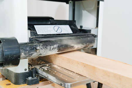 working with wood on the planing machineの写真素材