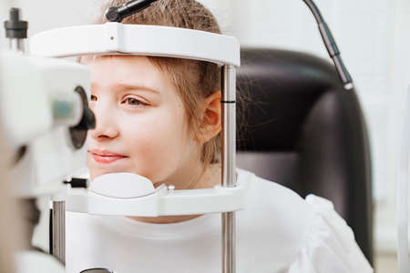 examination of girl with slit lamp. equipping ophthalmologists office.