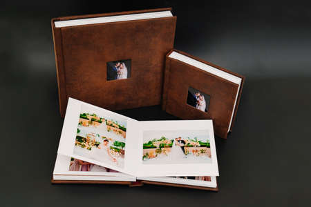 wedding photobooks in brown leather binding with photos on the coverの写真素材