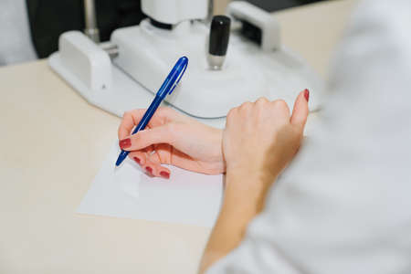 doctor interviews patient and makes entries in the medical historyの写真素材