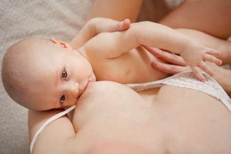 top view. a mother feeds the baby with breast milk. the breastfeeding.